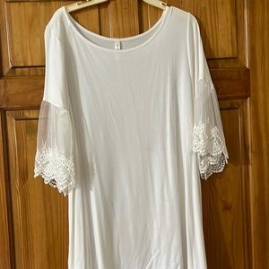 Blouse 3/4 sleeve w/ lace detail. Rayon and spandex. Soft, light ivory color.